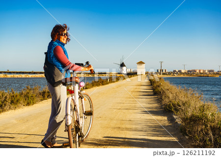 Woman with bike at San Pedro del Pinatar park, Spain Woman with bike at San Pedro del Pinatar park, Spain 126211192