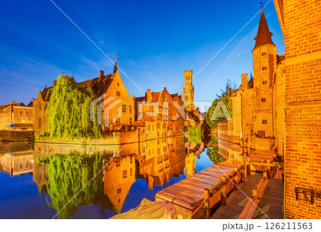 Bruges, Belgium. Twilight Rozenhoedkaai in golden hues water canal reflection 126211563