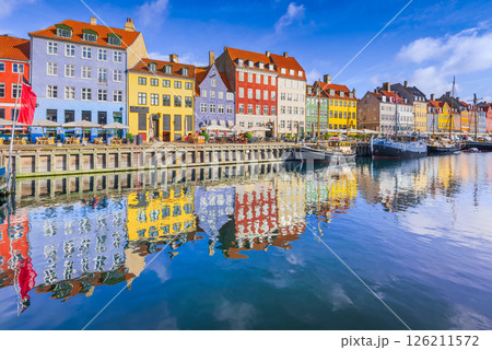 Copenhagen, Denmark. Nyhavn Canal is a vibrant harbor lined with colorful buildings and boats. 126211572