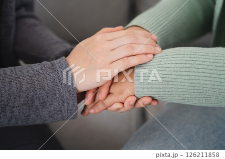 Psychologist, friend or family holding hands to encourage patient with depression, anxiety Psychologist, friend or family holding hands to encourage patient with depression, anxiety 126211858