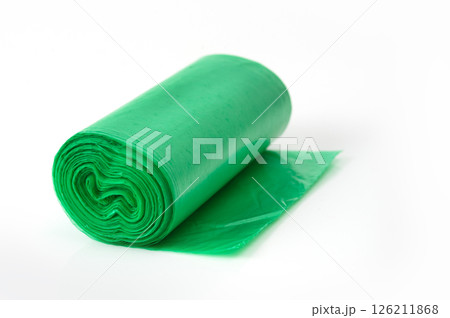 Green plastic garbage bag roll unrolled on white background, household waste bag for cleaning or trash disposal. 126211868