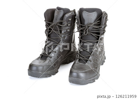 Black military combat boots with laces and rugged soles, front view on white background. Durable and sturdy footwear designed for outdoor activities and tactical use Black military combat boots with laces and rugged soles, front view on white background. Durable and sturdy footwear designed for outdoor activities and tactical use 126211959