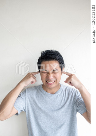 Man Covering Ears from Loud Noise or Sound Pollution 126212183