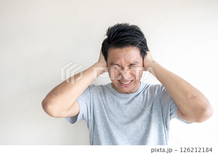 Man Covering Ears from Loud Noise or Sound Pollution 126212184