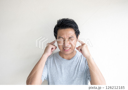 Man Covering Ears from Loud Noise or Sound Pollution 126212185