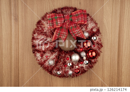Winter Christmas wreath on the door with twinkling lights. 126214174