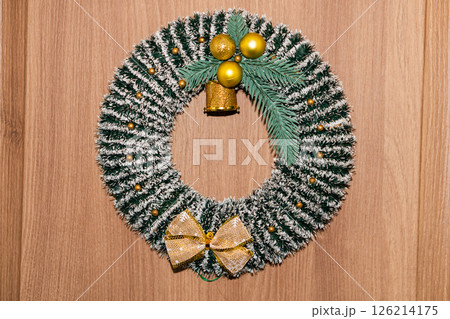 Classic wreath with red ribbon on a wooden door. 126214175