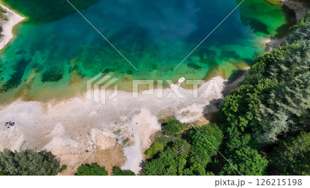 Vibrant emerald waters of a secluded lake surrounded by lush greenery and sandy shores create a serene escape into nature Generative AI Vibrant emerald waters of a secluded lake surrounded by lush greenery and sandy shores create a serene escape into nature Generative AI 126215198