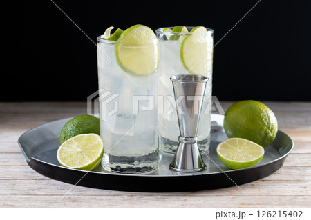 Gin Fizz cocktail with lime on black background 126215402