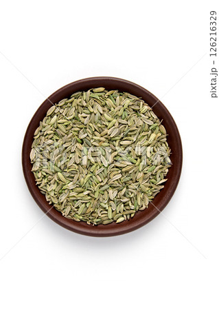 dried fennel seeds in brown clay bowl isolated on white background. top view with copy space 126216329