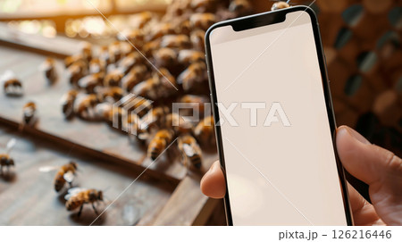 mockup phone copy space in hand with apiary and bees in background 126216446