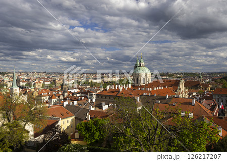 St. Nicholas Church dominating Prague cityscape under cloudy sky 126217207