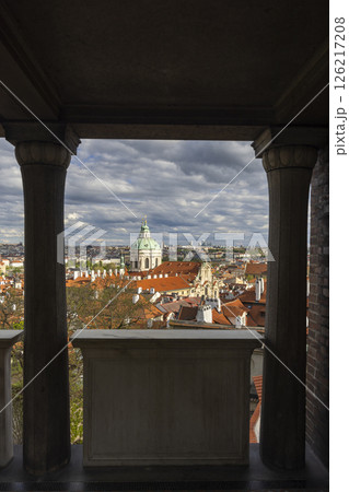 Panoramic view of Prague rooftops and St. Nicholas Church from a balcony 126217208