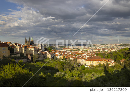 Prague Castle dominating the cityscape under dramatic cloudy sky in Czechia 126217209