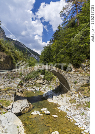 Old stone bridge crossing a mountain river in Navarre, Spain 126217285