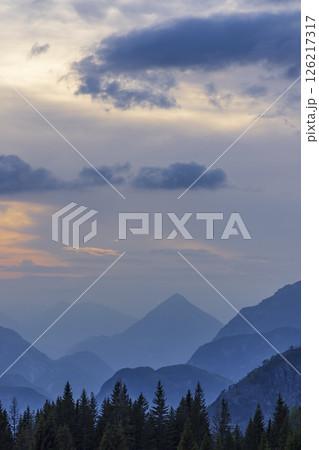 Stunning sunset illuminating blue mountains in Chiusaforte, Italy Stunning sunset illuminating blue mountains in Chiusaforte, Italy 126217317