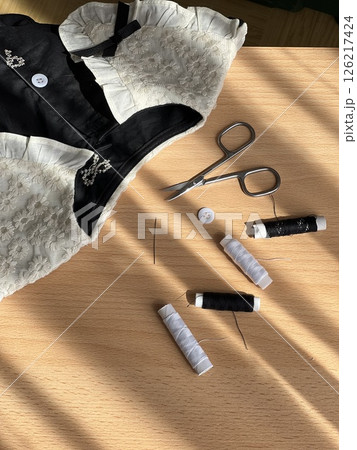 Sewing Tools and Lace Garment on Wooden Table 126217424