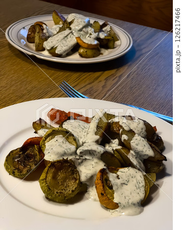 Baked vegetables with sauce on a wooden table 126217466