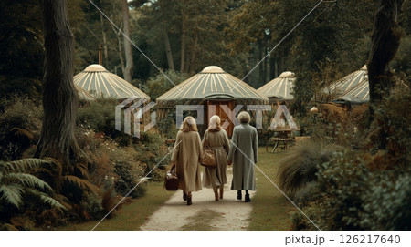 Mature friends stroll in nature near cozy lodgings 126217640