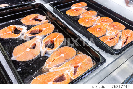 Steaks of fresh salmon fish on the counter. Raw red fish for sale. Seafood shop 126217745