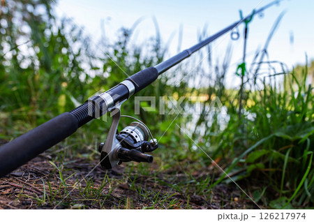 Fishing Blurred Background. Fishing Rod at the Lake. Summer, Spring, Calm, Mental, Silence, Meditation, Chill, Fish, Catch. Fishing Blurred Background. Fishing Rod at the Lake. Summer, Spring, Calm, Mental, Silence, Meditation, Chill, Fish, Catch. 126217974