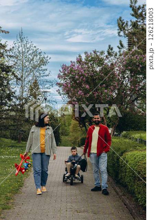 Life is simple when you love your family. Parents spending time with their children outside. Focus is on foreground. Life is simple when you love your family. Parents spending time with their children outside. Focus is on foreground. 126218003