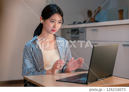 夜遅くにリモート会議をする若いビジネスパーソン 夜遅くにリモート会議をする若いビジネスパーソン 126218073