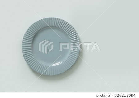 Elegant empty blue ceramic plate isolated on blue background. Mock up. Kitchen decor, food styling, or dining presentations. Newborn color. 126218094