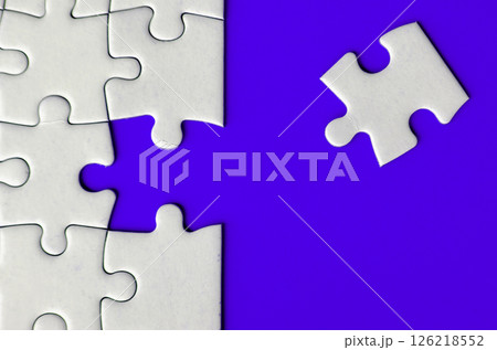 Connecting missing white jigsaw puzzle symbolizes partnership and unity on blue background 126218552