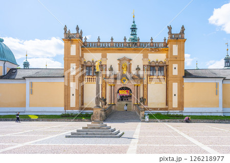 Visitors explore the impressive Baroque complex at Holy Mountain in Pribram, Czechia, a renowned pilgrimage site, showcasing its detailed architecture under a clear blue sky. Visitors explore the impressive Baroque complex at Holy Mountain in Pribram, Czechia, a renowned pilgrimage site, showcasing its detailed architecture under a clear blue sky. 126218977