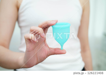 Asian woman holding menstrual cup for hygiene menstrual period cycle protection. 126221408