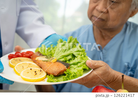 Asian Nutritionist holding healthy food for patient in hospital, nutrition and vitamin. Asian Nutritionist holding healthy food for patient in hospital, nutrition and vitamin. 126221417