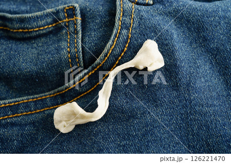 Dirty chewing gum stain removal on cloth jean accident to wash with washing powder, cleaning housework. Dirty chewing gum stain removal on cloth jean accident to wash with washing powder, cleaning housework. 126221470