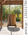 Old wooden barrel under rustic shelter 126221780
