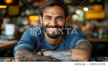 Smiling Tattooed Man in a Coffee Shop Setting 126222326