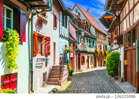 Eguisheim, Alsace - France. Picturesque village with colorful half-timbered houses, cobblestone streets, flower-filled balconies and scenic vineyards 126225086