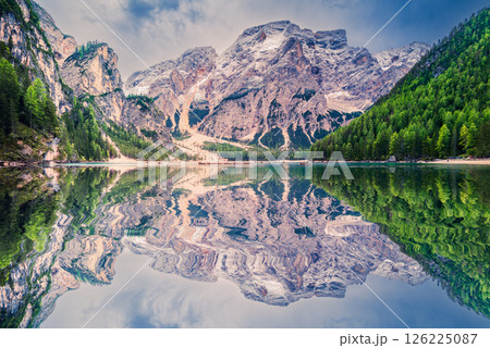 Lago di Braies, Italy. Alpine lake with emerald waters, dramatic Dolomites peaks, wooden boats, and breathtaking scenic beauty. 126225087