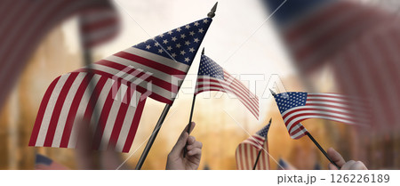 A group of people holding USA flags in their hands A group of people holding USA flags in their hands 126226189