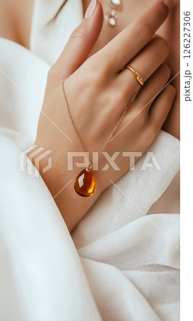 A detailed artistic close-up of a hand adorned with gold jewelry amidst a bubble-laden surface, emphasizing elegance and softness with a luxurious feel. Jewelry, lifestyle, and beauty themes. 126227306
