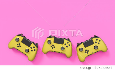 Realistic yellow video game joysticks or gamepads on pink background 126228681