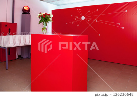 Modern red reception stand with gift bags and flower vase 126230649