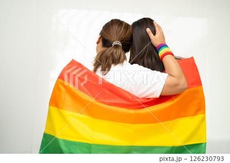 Asian couple woman with LGBT rainbow flag. 126230793