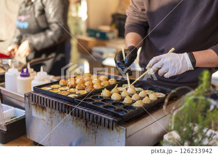 Process of cooking takoyaki balls. 126233942