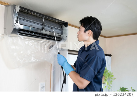 ハウスクリーニングの男性作業者が行うエアコン清掃 ハウスクリーニングの男性作業者が行うエアコン清掃 126234207