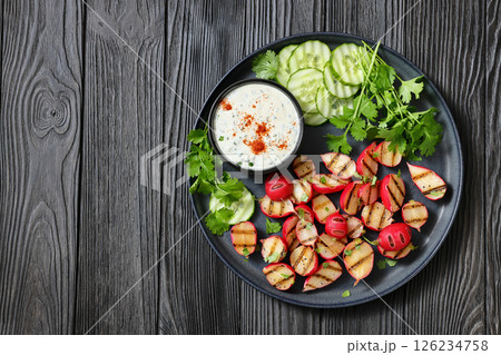 grilled radishes with cucumber slices and sauce grilled radishes with cucumber slices and sauce 126234758