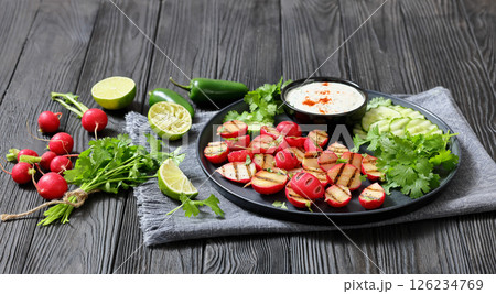 grilled radishes with cucumber slices and sauce grilled radishes with cucumber slices and sauce 126234769