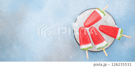 Homemade strawberry ice cream popsicles on white plate, Summer food concept. Top view 126235531