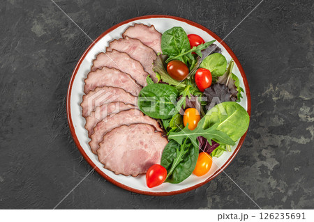 meat sausages slices with salad on a dark background. top view. copy space for text meat sausages slices with salad on a dark background. top view. copy space for text 126235691