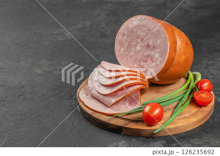 Tasty meat sausages. Turkey Boiled Ham on a wooden board, top view. copy space 126235692