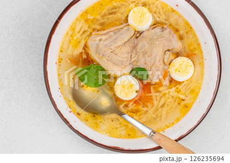 Quail broth or soup in a bowl on a white background top view. copy space Quail broth or soup in a bowl on a white background top view. copy space 126235694